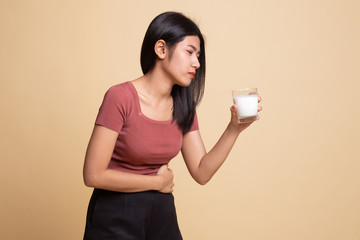 Asian woman drinking a glass of milk got stomachache.