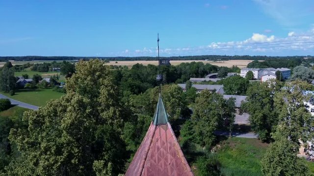 Aerial Dron Shot of the Cirava Lutheran Church Aizpute  Latvia, Sunny Summer Day. Flaying Above the  Church and Manor Castle.