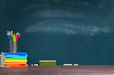 Pencil holder on books on school teacher's desk