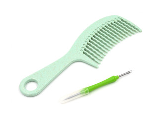 Comb and ear cleaning device isolated on white background.