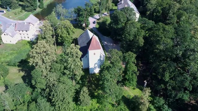 Aerial Dron Shot of the Cirava Lutheran Church Aizpute  Latvia, Sunny Summer Day. Flaying Above the  Church and Manor Castle.