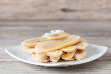 Boiled slice banana eat with coconut
