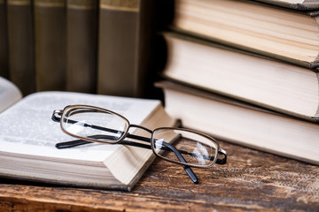 The glasses lie on the open book in the library