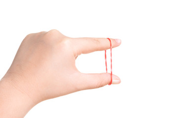 Child hand playing with elastic rubber band isolated on white