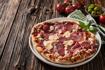 Pepperoni or salami Italian pizza with mozzarella