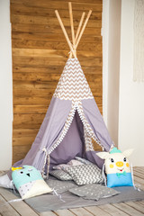 Children's room in a rustic style. Blue wigwam in a children's room. Interior details of a bright Scandinavian nursery. © Nelly