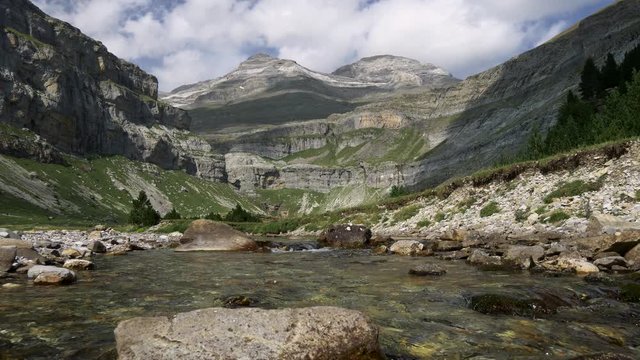 Stream flowing at the foothills in Ordesa y Monte Perdido National Park, Huesca, Aragon, Spain. Mount Perdido is seen in the background. This site is close to French border. Steadicam, UHD