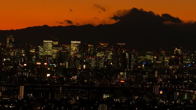 Timelapse panning shot of Ichikawa city illuminated at night, Japan