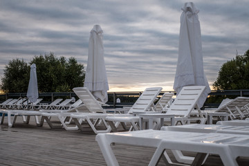 Fototapeta premium Hotel lounge area with swimming pool and sun loungers