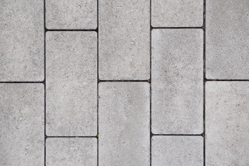 gray paving slabs laid in straight rows. texture, background.