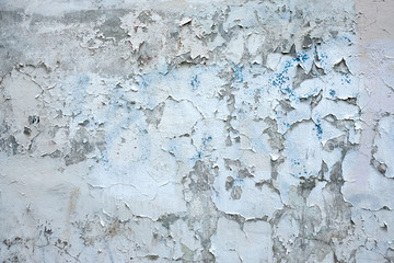 Old peeling white wall. Old paint on the wall