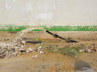 Old Plastic Water Pipe cutting with water flowing while changing new water pipe.