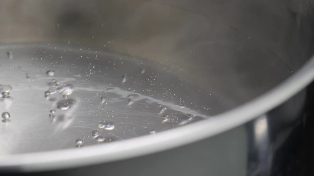 steam rising from pot with boiling water