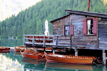 village house and boats on lake smooth as lake braies italy