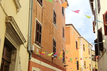 Mediterranean yellow-orange houses with colorful flags, Slovenia, Piran