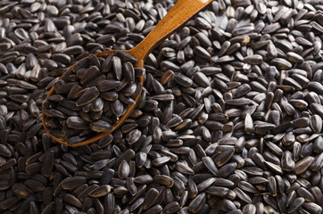 Closeup of wooden spoon on the just roasted sunflower seeds