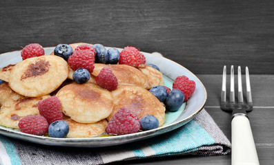 Pancakes with berries and maple syrup