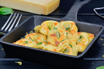 Italian traditional tortellini pasta in a pan