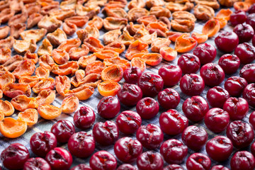 Background of fresh mellow cherries and apricots prepared for cooking