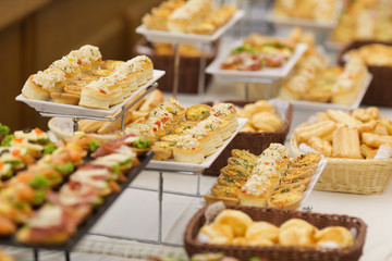 Shallow depth of field image with appetizers on a table at an event, provided by a catering company