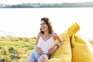 Smiley woman sitting on beanbag