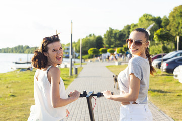 Back view women on scooter looking at the camera