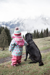 The friendship between a child and her black dog