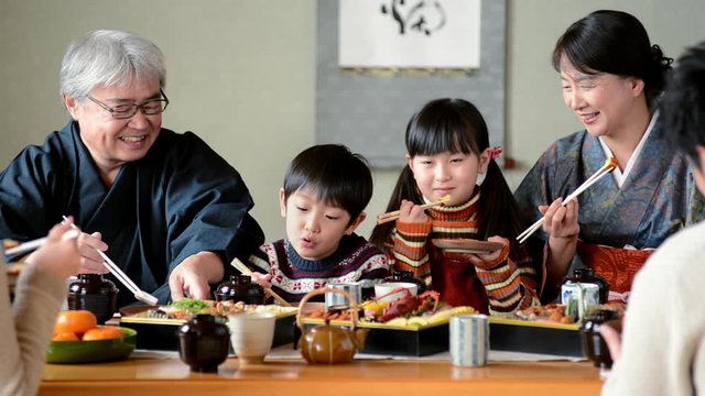 Close up of three generation family eating dinner