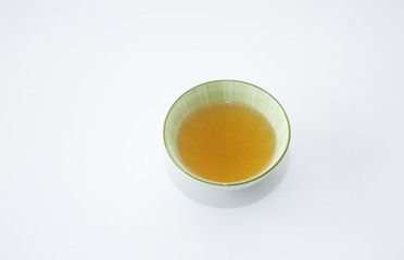 green tea in a bowl Isolated on a white background. It is a rich source of antioxidants and polyphenols. A healthy drink for health and vitality. Top view. With copy space for text and image.
