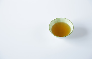 green tea in a bowl Isolated on a white background. It is a rich source of antioxidants and polyphenols. A healthy drink for health and vitality. Top view. With copy space for text and image.