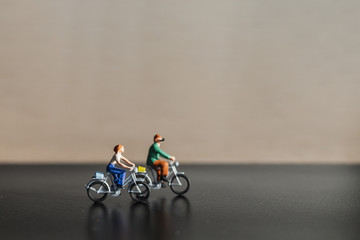 Miniature people : Travelers riding bicycle with copy space , Healthy lifestyle concept