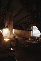 Fototapeta na wymiar beautiful evening light shining through window of a cottage