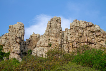 Rocks cliff with sky background suitable for saving environment poster and wallpaper background.
