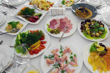 Table with food in the restaurant. Festive dishes at the festival.