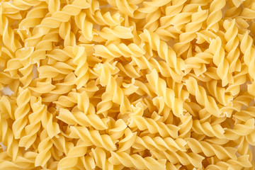 raw macaroni spirals as background