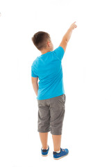 Back view of little boy points at wall. Rear view. Isolated on white background 