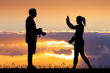 boy and girl photographers at sunset