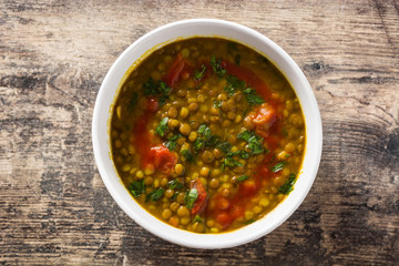 Indian lentil soup dal (dhal) in a bowl on wooden table. Top view. 