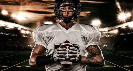 Fototapeta na wymiar American football sportsman player in helmet on stadium. Sport wallpaper.