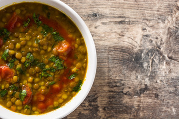 Indian lentil soup dal (dhal) in a bowl on wooden table. Top view. Copyspace