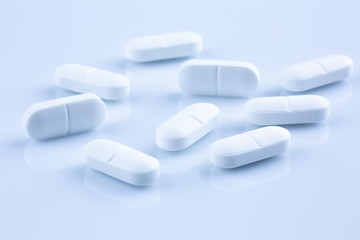 Closeup of white antibiotic pills.