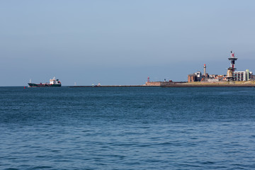 Seascape Dutch city Vlissingen with cargo ship sailing near coast