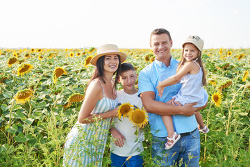 Father, mother and baby daughter in sunflowers field.Children Protection, mothers and Fathers Day. Family Summer vacation traveling. Holidays in village.  Freedom concept. 