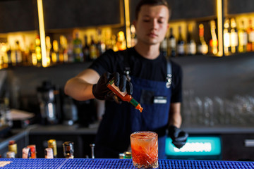 barman make a cocktail in a restaurant