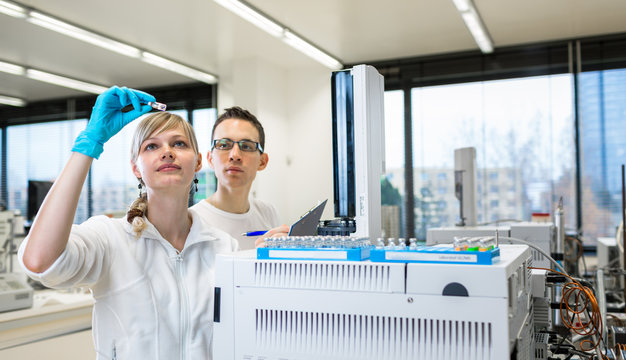 senior male researcher carrying out scientific research in a lab using a gas chromatograph (shallow DOF; color toned image)