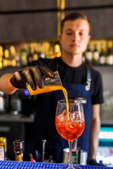 barman make a cocktail in a restaurant
