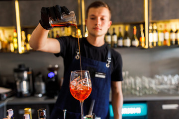 barman make a cocktail in a restaurant