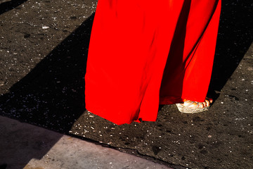 Detail of shoes and red dress