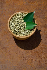 green coffee beans in wooden bowl