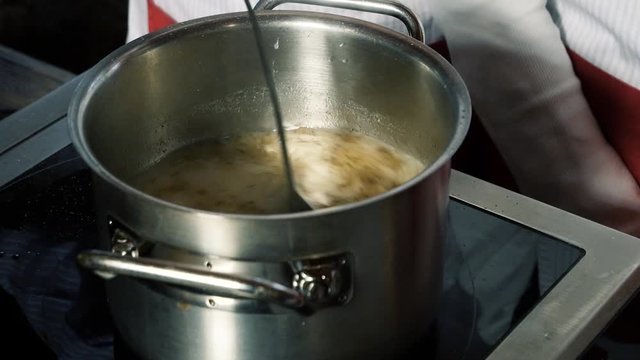 cooking a soup in a metal saucepan